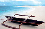 a native boat lying on the beach